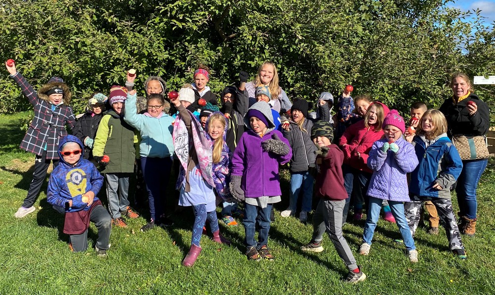 2nd graders show off the apples they picked at the orchard